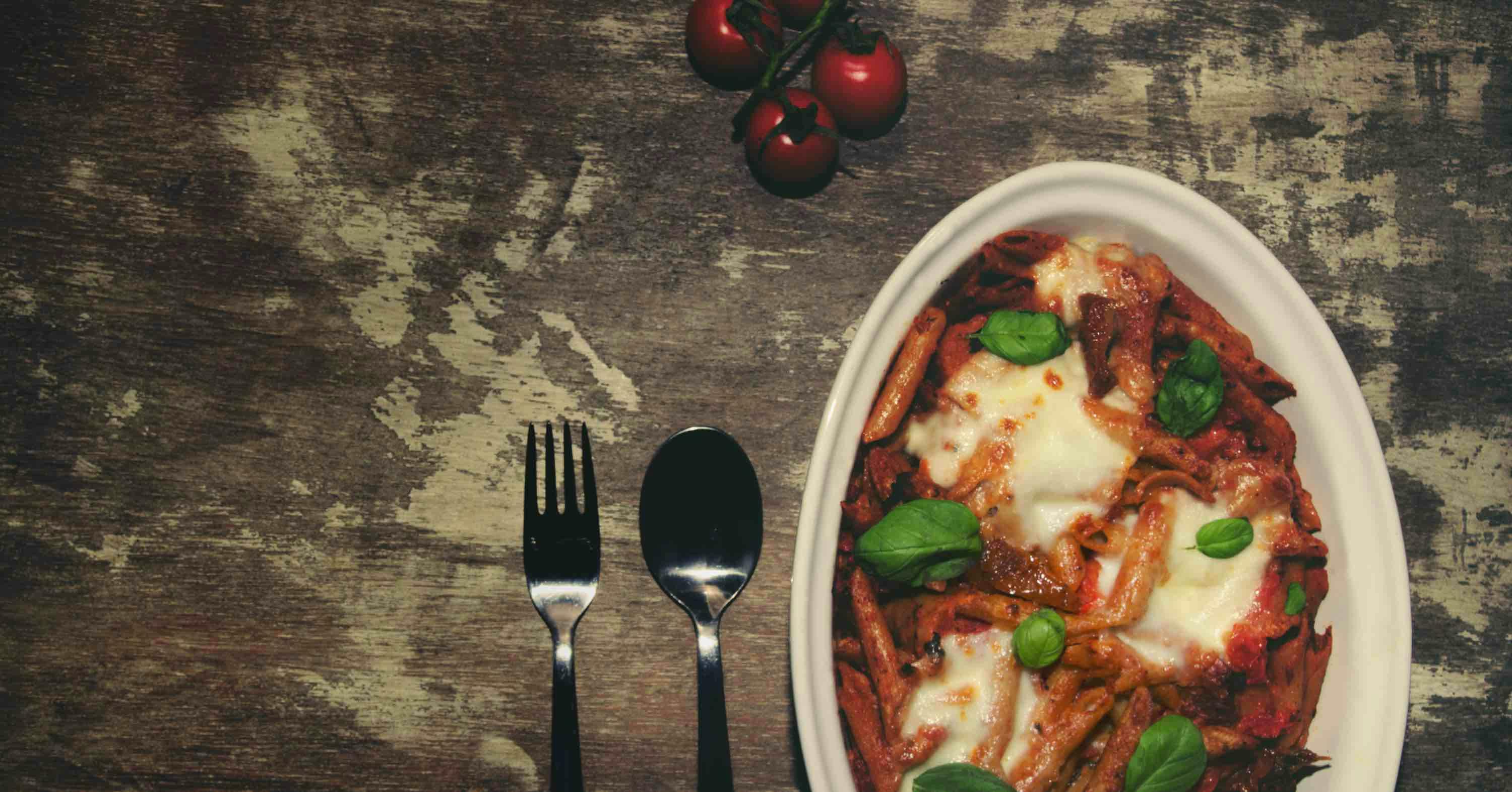 Mouth watering vegetarian pasta bake with rich tomato sauce and cheese toppings